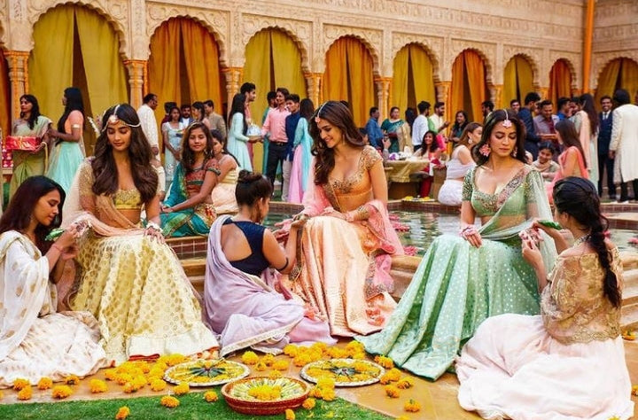 Bollywood mehndi scene showcasing actresses wearing luxury artificial floral jewelry by Prune India