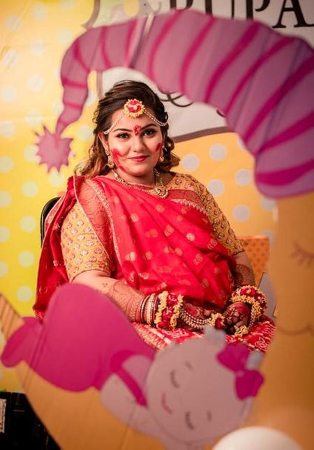 A mom to be wearing floral jewelry on her baby shower, Indian god bharai