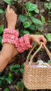Woman's hand wearing a pink signature silk bangle, holding a floral basket – perfect for mehndi, haldi, or bridesmaid gifting