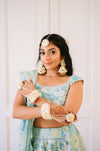 Real Prune bride wearing Whispers of Spring off-white floral jewelry set for her Haldi ceremony.