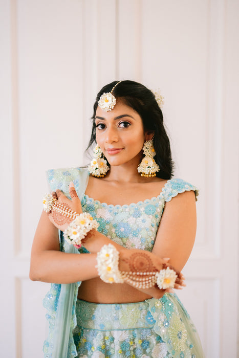 Real Prune bride wearing Whispers of Spring off-white floral jewelry set for her Haldi ceremony.
