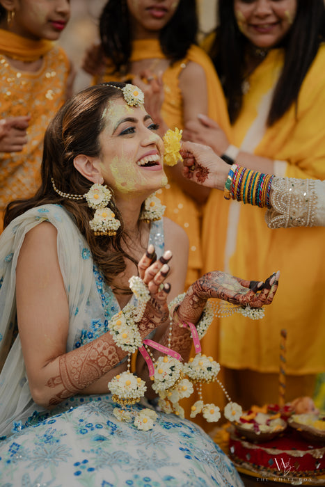 Close-up of handcrafted Noor floral Jhumkas earrings on an elite South Asian bride.