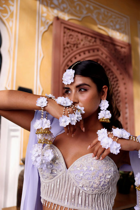 Close-up of handcrafted silk petals and intricate beadwork on Prune luxury floral Haath Phool.