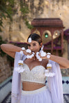 Modern white floral Maang Tikka and flowing kaleere for luxury Sikh weddings.