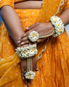 Close-up of handcrafted floral jhumkis with kaanchain on a real bride for a winter wedding.