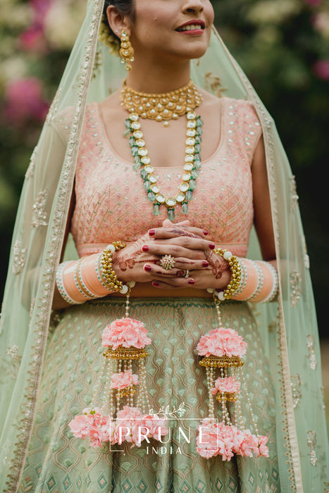 Side-by-side view showing the 10-inch length of the Royal PIFK 0041 kaleere against a bridal sleeve to demonstrate the grand statement size.